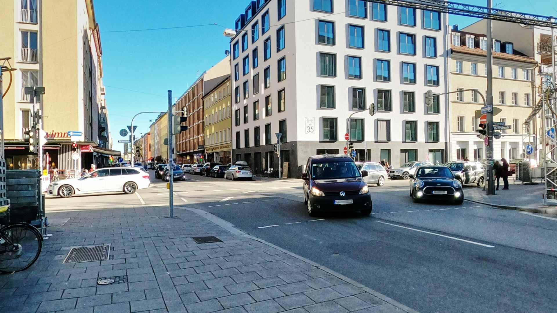 Street intersection with old building facades and a modern office building near the retail space in Munich Maxvorstadt