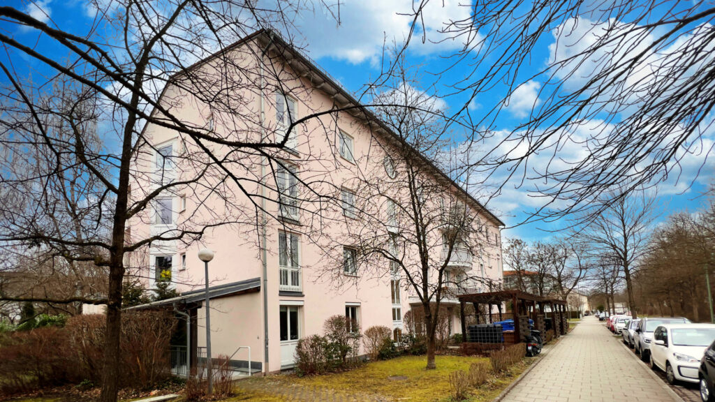 White residential building with a gable roof and walkway in the Untermenzing district of Munich