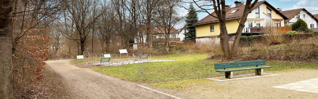 Park path with a bench and trees in the Untermenzing district of Munich