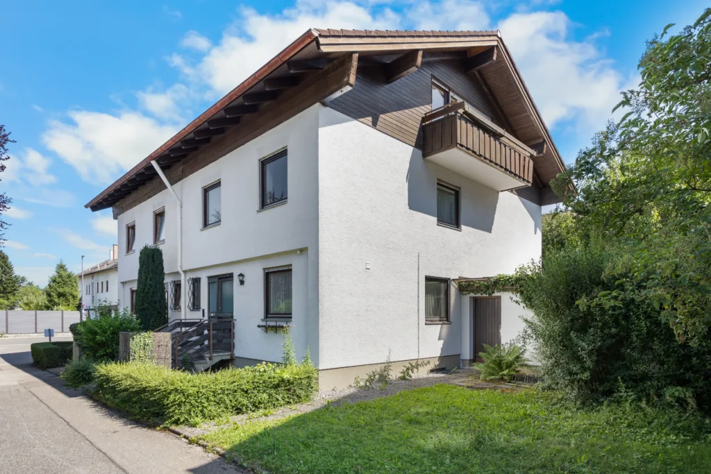 Exterior view of the semi-detached house with a gable roof and balcony
