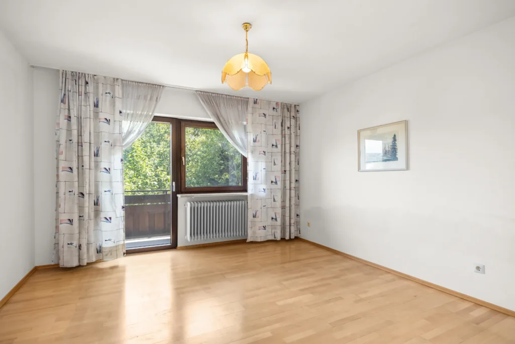 Unfurnished bedroom with balcony access and parquet flooring