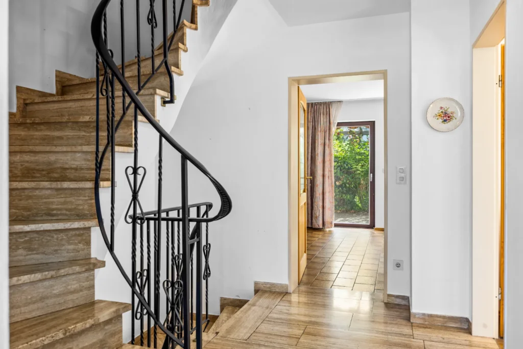 Curved staircase with wrought iron railing in the entrance area