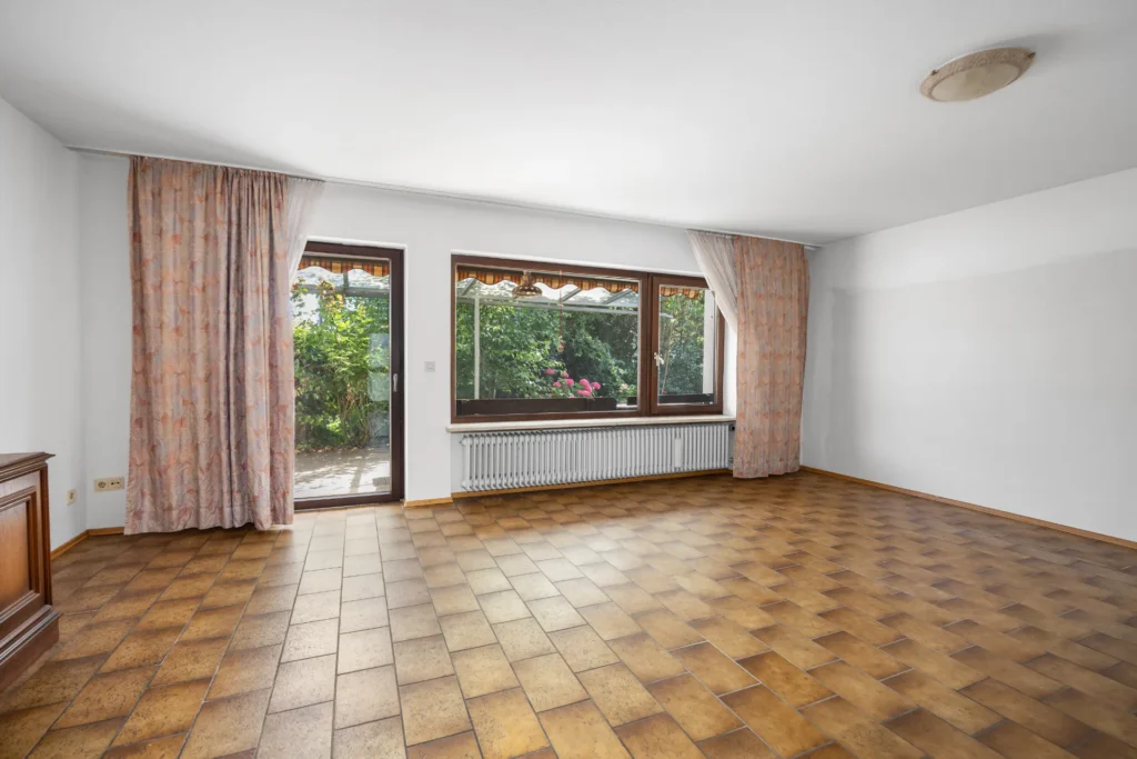 Spacious living room with a large window front and patio door